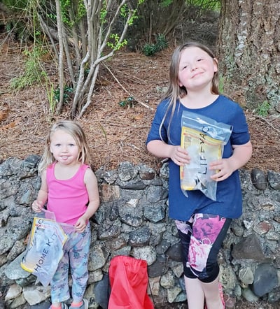 Kayla's daughters Sofie and Emily holding their LifeVac kits.