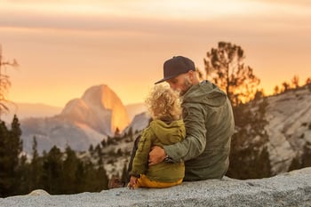 dad-and-child-on-mountain-at-sunset